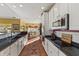 Galley kitchen featuring granite counters, white cabinets, and stainless steel appliances at 5115 Baltustrol Dr, Avon, IN 46123
