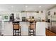 Open concept kitchen with granite counters, stainless steel appliances, white cabinets, and breakfast bar at 5115 Baltustrol Dr, Avon, IN 46123