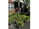 Landscaped flower bed with colorful roses, iris, and fresh mulch at the front entrance at 5115 Baltustrol Dr, Avon, IN 46123