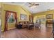 Bright living room features wood floors, neutral walls, and plenty of natural light from the large windows at 5115 Baltustrol Dr, Avon, IN 46123