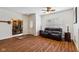 Inviting living room with wood floors, bright natural light, and modern ceiling fan at 5115 Baltustrol Dr, Avon, IN 46123