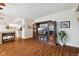 Bright living room with hardwood floors, a cozy fireplace, and a view into the open kitchen space at 5115 Baltustrol Dr, Avon, IN 46123