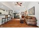 Open-concept living room featuring fireplace, plush furniture, and seamless kitchen access at 5115 Baltustrol Dr, Avon, IN 46123