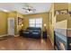 Comfortable living room with a leather sofa, natural light, fireplace, and ceiling fan creating a relaxing atmosphere at 5115 Baltustrol Dr, Avon, IN 46123