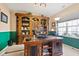 Dedicated office featuring a large desk, custom shelving, and a bright window creating an ideal workspace at 5115 Baltustrol Dr, Avon, IN 46123