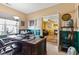 Well-lit office with a large desk, an open doorway to living room, and a calming view creating an ideal work environment at 5115 Baltustrol Dr, Avon, IN 46123