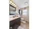 Bright bathroom with dark wood vanity, and white tile shower at 5195 N Frontage Rd, Fairland, IN 46126