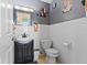 Bathroom with classic white tile and dark gray accents, vanity with decorative Halloween-themed decorations at 5195 N Frontage Rd, Fairland, IN 46126