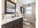 Bright bathroom with dark wood vanity, and white tile shower at 5195 N Frontage Rd, Fairland, IN 46126