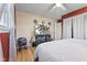 Comfortable bedroom with hardwood floors, modern ceiling fan, and stylish media console with TV at 5195 N Frontage Rd, Fairland, IN 46126