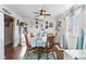 Cozy dining room features wood floors, ceiling fan, and light teal walls with decorative wall art at 5195 N Frontage Rd, Fairland, IN 46126