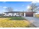 Charming ranch style home with a 2-car garage, and beautifully decorated front lawn at 5195 N Frontage Rd, Fairland, IN 46126
