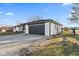 Wide view of a ranch style home showing a 2-car garage and a pea gravel driveway at 5195 N Frontage Rd, Fairland, IN 46126
