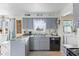 Bright kitchen showcasing a stainless steel dishwasher and gray cabinets at 5195 N Frontage Rd, Fairland, IN 46126
