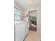 Laundry room with washer and dryer hookups leading to adjacent living room with a ceiling fan at 5195 N Frontage Rd, Fairland, IN 46126