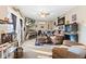 Comfortable living room features reclining leather furniture, ceiling fan and door to backyard at 5195 N Frontage Rd, Fairland, IN 46126