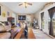 Open living room features a door to backyard and view of the kitchen and dining area at 5195 N Frontage Rd, Fairland, IN 46126