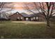 Large backyard with a partial fence, lush grass, and a patio area, perfect for outdoor activities and relaxation at 520 Denny Dr, Mooresville, IN 46158