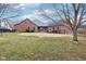 Wide backyard with brick home and partial fence surrounded by mature trees at 520 Denny Dr, Mooresville, IN 46158