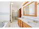 Bathroom featuring a double sink vanity, a bathtub, and a glass-enclosed shower at 520 Denny Dr, Mooresville, IN 46158