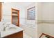 Bathroom featuring a double sink vanity, a bathtub, and a window for natural light at 520 Denny Dr, Mooresville, IN 46158