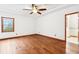 Bright bedroom featuring hardwood floors, a ceiling fan, and windows providing natural light at 520 Denny Dr, Mooresville, IN 46158