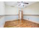 Bedroom featuring hardwood floors, a ceiling fan, and wood trim at 520 Denny Dr, Mooresville, IN 46158