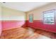 Cozy bedroom with natural light streaming through two windows, highlighting the hardwood floors at 520 Denny Dr, Mooresville, IN 46158