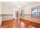 Dining room featuring hardwood floors, trim, and a view of the front entry at 520 Denny Dr, Mooresville, IN 46158