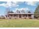 Charming brick home featuring a spacious front porch and lush lawn, perfect for relaxing or entertaining outdoors at 520 Denny Dr, Mooresville, IN 46158