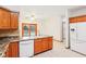 Bright kitchen featuring wood cabinetry, granite countertops, tile flooring, and sliding glass doors leading to a deck at 520 Denny Dr, Mooresville, IN 46158