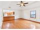 Spacious living room featuring wood floors, a ceiling fan, and a seamless transition to the kitchen at 520 Denny Dr, Mooresville, IN 46158