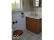Cozy bathroom with tile floor, vanity with sink and cabinet, and window at 5851 Brobeck Ln, Indianapolis, IN 46254