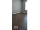 Clean and neutral bedroom featuring hardwood floors, a window for natural light, and painted walls at 5851 Brobeck Ln, Indianapolis, IN 46254