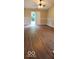 Bright living room featuring wood floors, modern ceiling fan, and sliding glass doors to the backyard at 5851 Brobeck Ln, Indianapolis, IN 46254