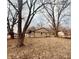 Spacious backyard showcases a cozy single-story home nestled among mature trees and a leafy ground cover at 6116 Wixshire Dr, Indianapolis, IN 46254