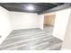 Spacious basement with modern vinyl plank flooring and neutral color palette, perfect for customization at 632 Middleham Cir, Beech Grove, IN 46107