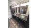 Bathroom with granite countertops, glass vessel sinks, and ornate shower visible in the mirror at 632 Middleham Cir, Beech Grove, IN 46107