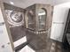 Stunning shower featuring unique tilework, arched windows, and luxurious fixtures at 632 Middleham Cir, Beech Grove, IN 46107