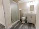 Clean bathroom with a glass shower, white vanity, modern sink and matching white toilet at 632 Middleham Cir, Beech Grove, IN 46107