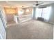 Upstairs bonus room with carpeting, ceiling fan, and decorative lighting, bathed in natural light from large windows at 632 Middleham Cir, Beech Grove, IN 46107