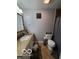 Bathroom featuring a granite countertop, vanity, commode, and shower/tub combo at 6721 Jackson St, Anderson, IN 46013