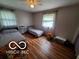 Bedroom featuring wood floors, two twin beds, and natural light at 6721 Jackson St, Anderson, IN 46013
