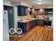 Modern kitchen with granite countertops and stainless steel appliances at 6721 Jackson St, Anderson, IN 46013