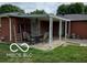 Covered back patio featuring a seating area, perfect for outdoor dining and entertaining at 6721 Jackson St, Anderson, IN 46013
