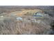 Expansive aerial view showcases the property's layout, pond, surrounding fields and wooded areas at 7143 W 50 S, Morgantown, IN 46160
