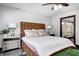 Comfortable bedroom features tufted leather headboard, pendant lighting, and an ensuite bathroom at 7143 W 50 S, Morgantown, IN 46160