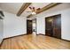 Open bedroom featuring exposed beams, and hardwood floors creating a warm and inviting atmosphere with natural light at 7143 W 50 S, Morgantown, IN 46160