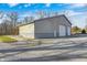Large shop with multiple garage doors and exterior lighting; ample space for storage and projects at 7143 W 50 S, Morgantown, IN 46160