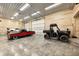 Well-organized garage featuring ample space for vehicles and recreational equipment with bright, even lighting at 7143 W 50 S, Morgantown, IN 46160